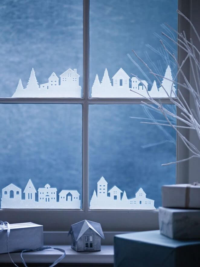 A snowy village in paper glued to the windows