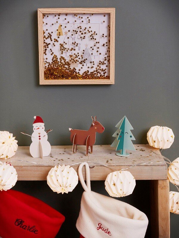 A frame with fir trees covered in starry glitter (1)
