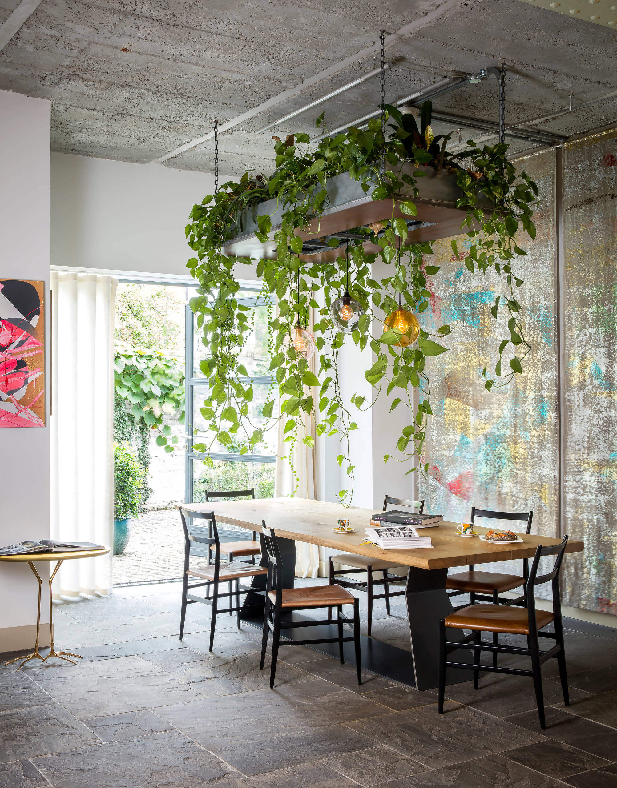 A plant composition suspended above the dining table 