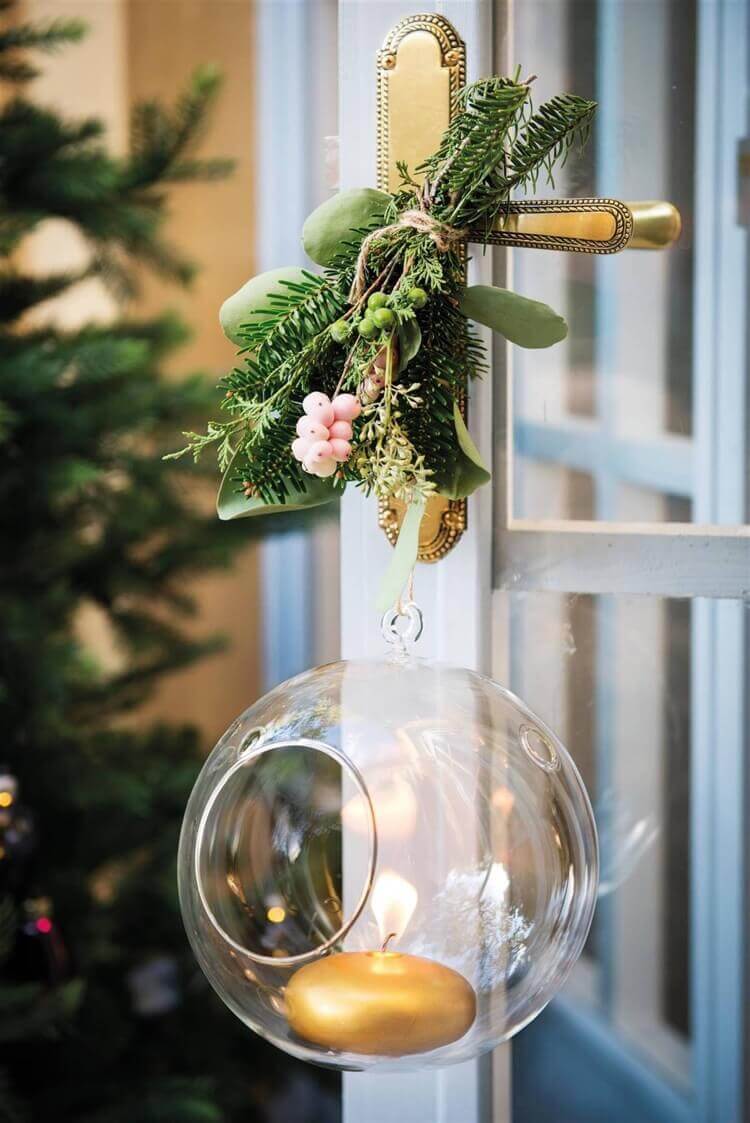 An open glass Christmas bauble and a small bouquet adorn the door handle (1)