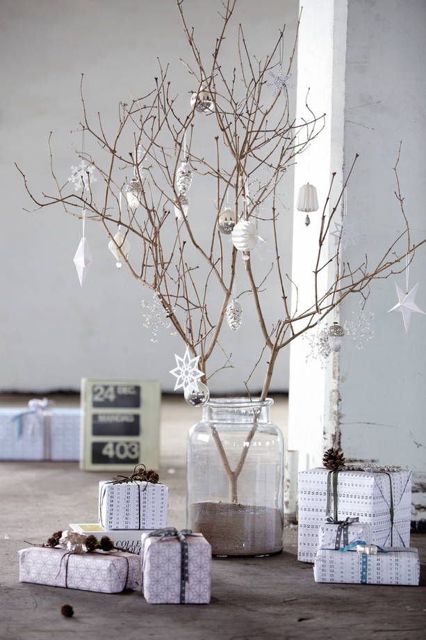 Small improvised Christmas tree made from barked branches, decorated with white suspensions