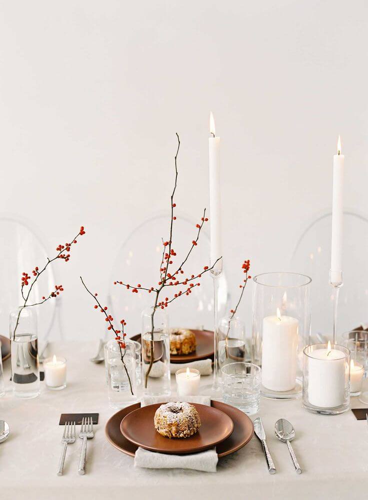 The Christmas table relies on the branches of red berries