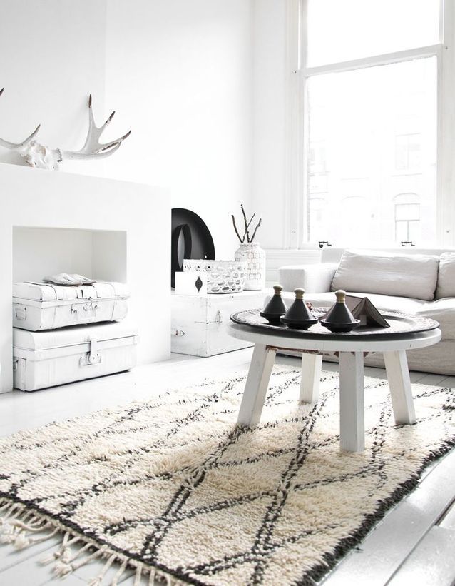 A WHITE LIVING ROOM ENHANCED WITH BLACK ACCENTS