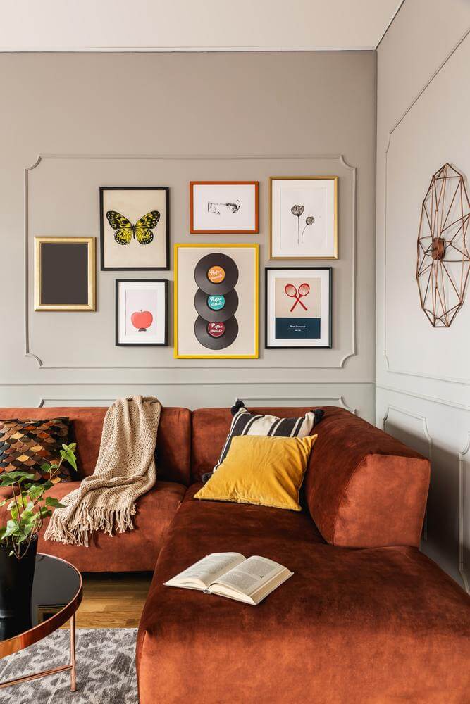 A wall of colorful frames framed by moldings (1)