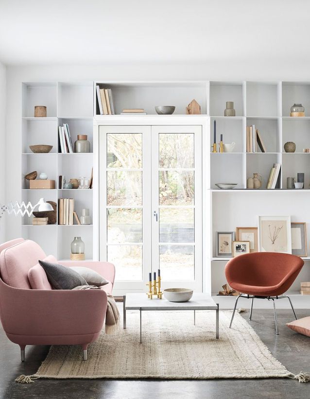 A white living room animated by a large library