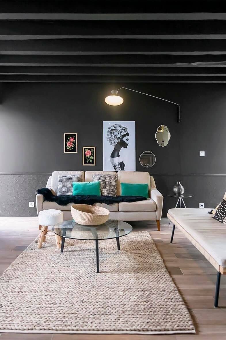 contemporary living room by opting for black on the walls and exposed beams (1)