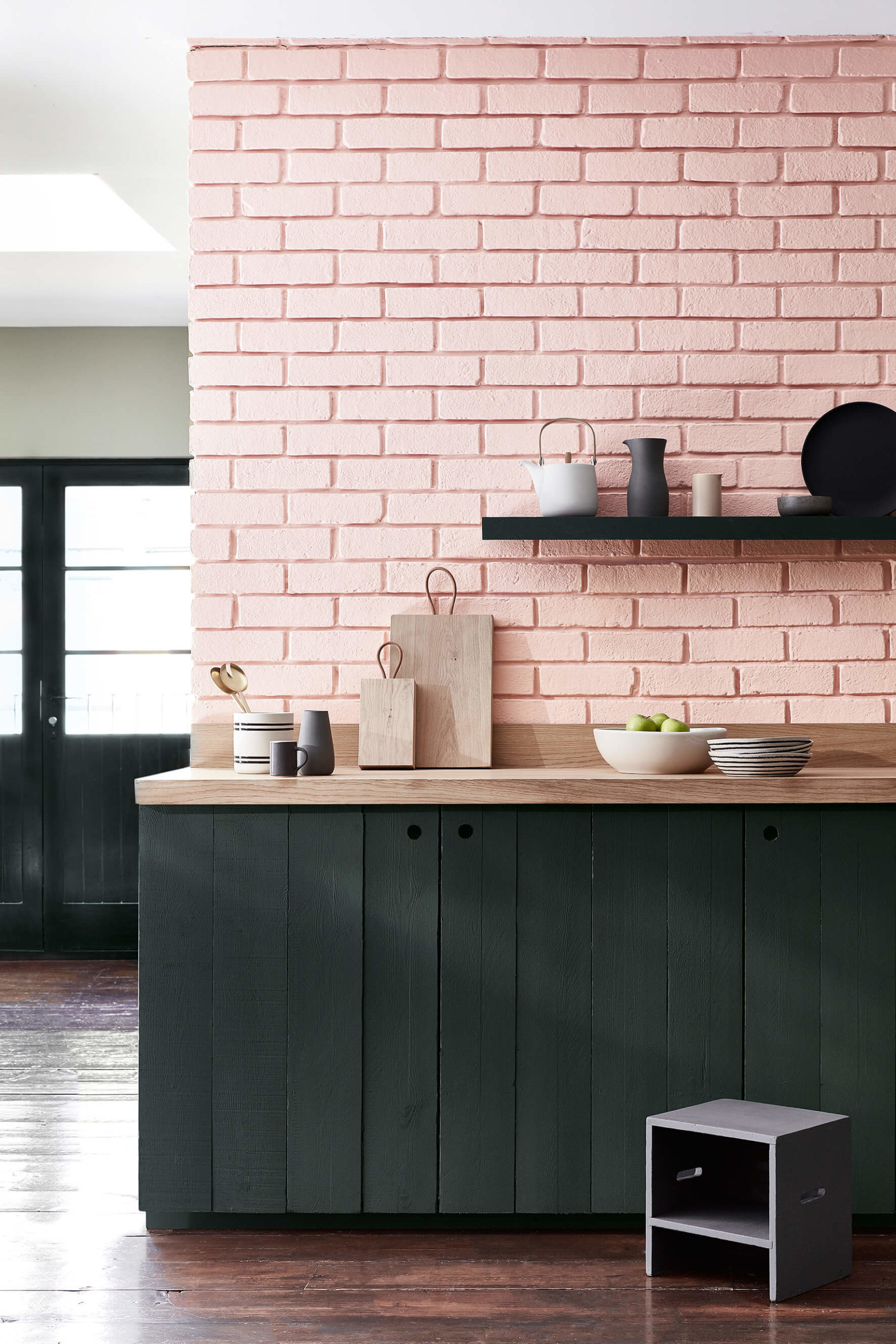 A kitchen with a pastel pink wall (1)