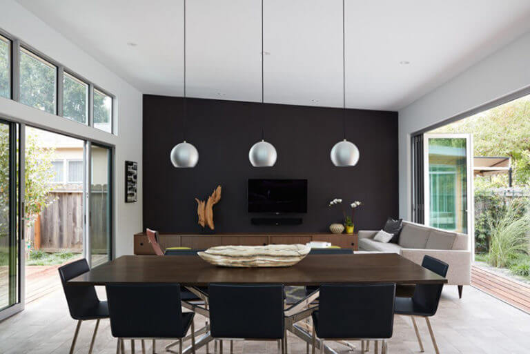 A mid-century modern dining room defined by dark colors (1)