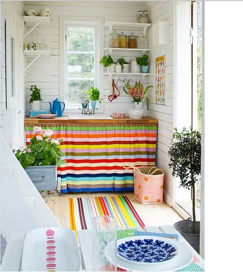 A small kitchen embellished with colorful stripes (1)