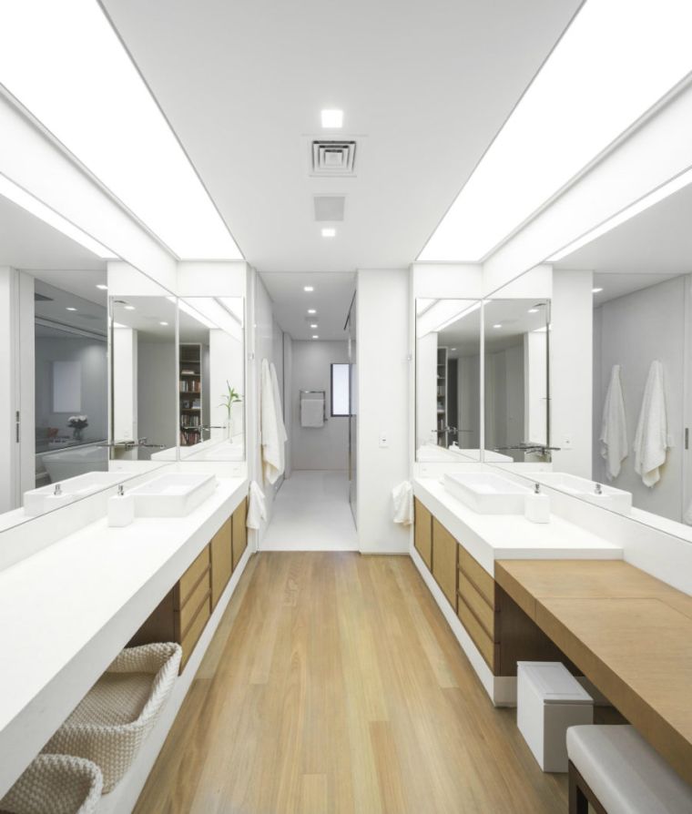 Hallway-style bathroom with large decorative mirrors