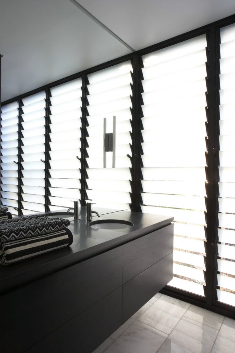 natural lighting of a bathroom with windows and large contemporary mirror