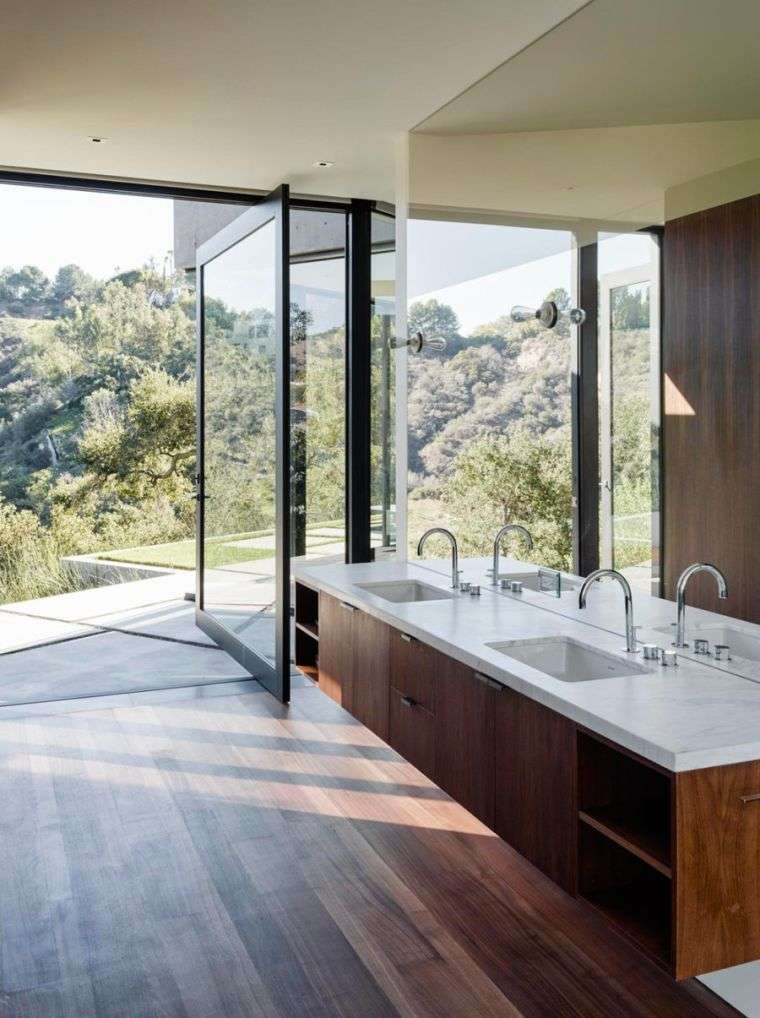 put a large wall mirror to emphasize a landscape outside the bathroom