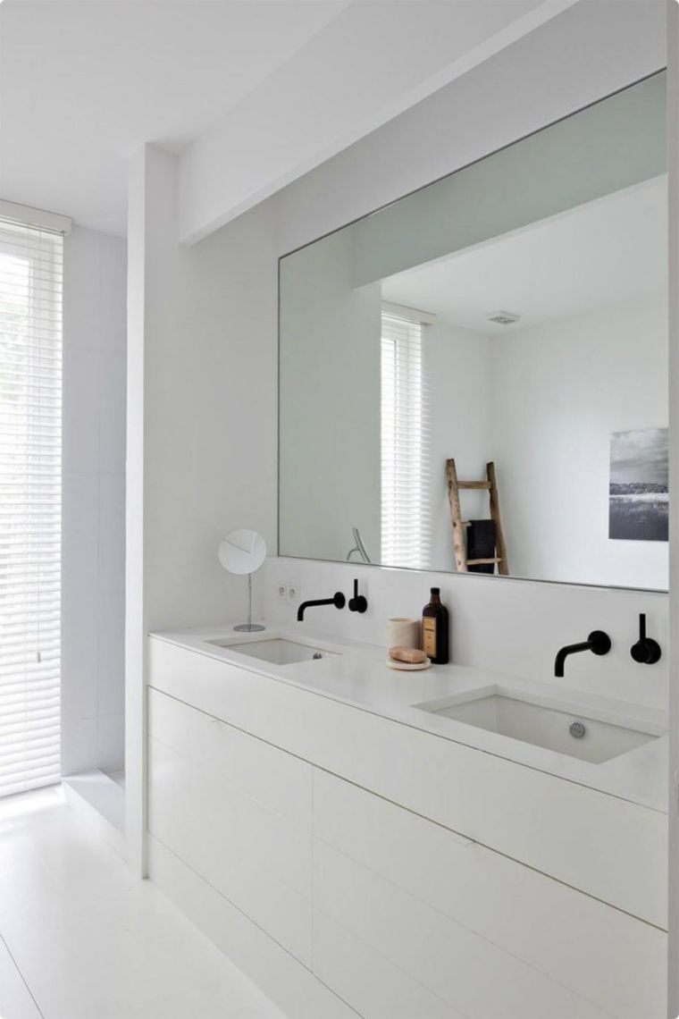 white bathroom with wall niche and rectangular decorative mirror