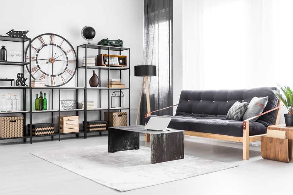 The black sofa in the center of an industrial living room (1)