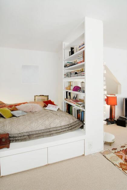 14- A large shelf acts as a partition in the bedroom