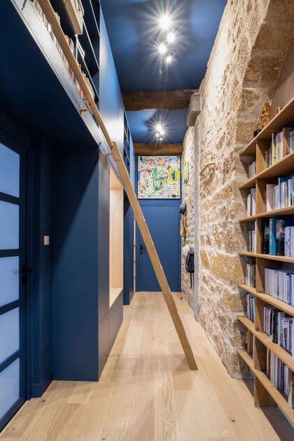 5- The colorful bookcase gives a function to a long hallway