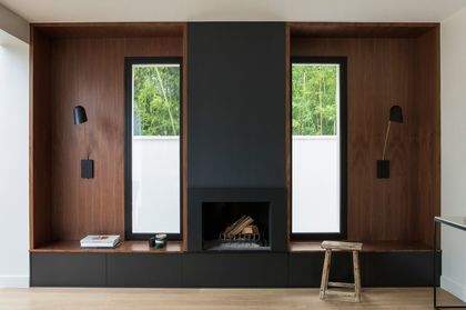 7- A monochrome fireplace offers the elegance of walnut cladding