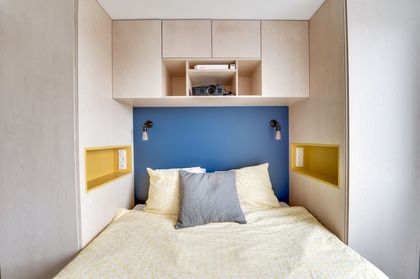 7- The bed in this bedroom is nestled in a cocoon of practical storage